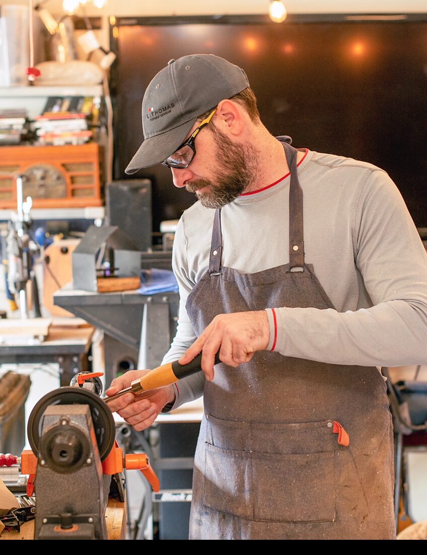 Lester Thomas at work on a wood lathe