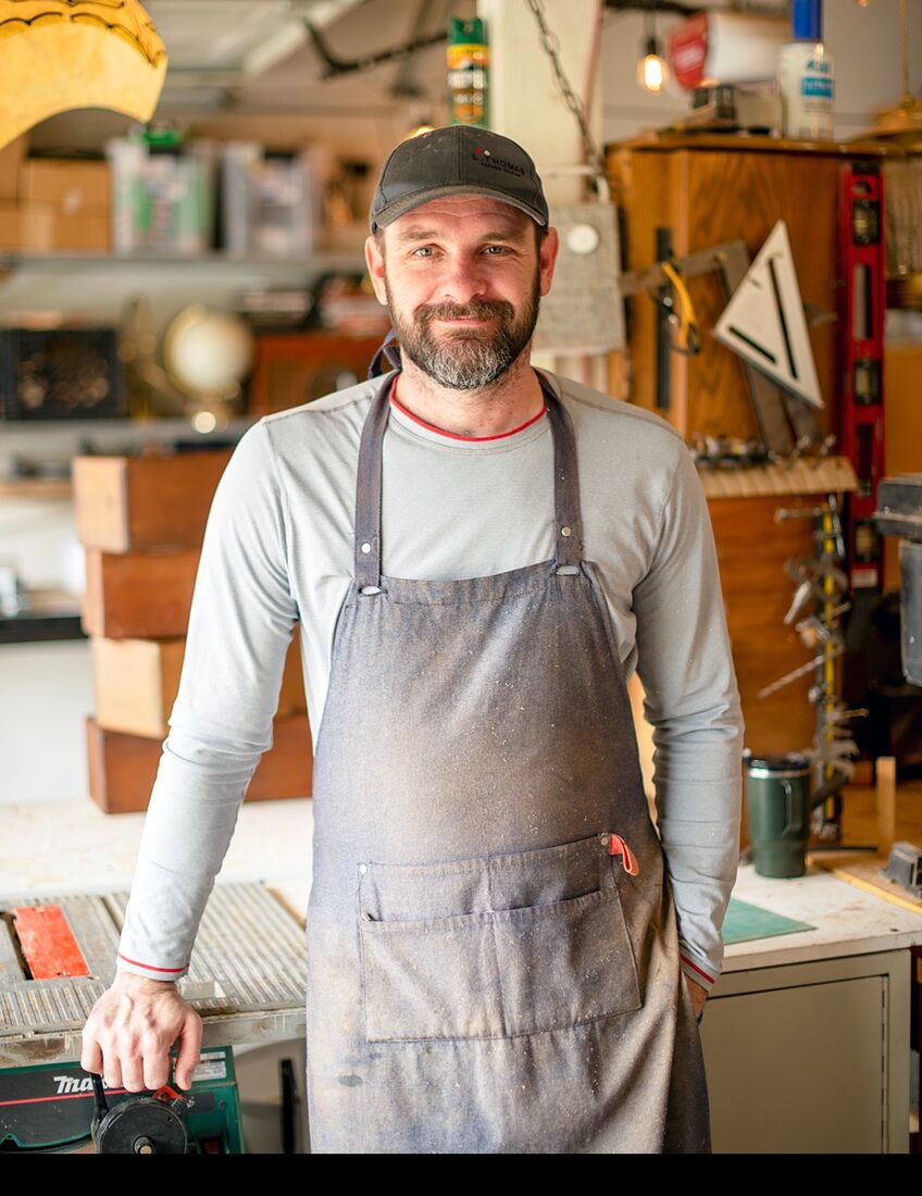 Lester Thomas standing in his woodworking shop