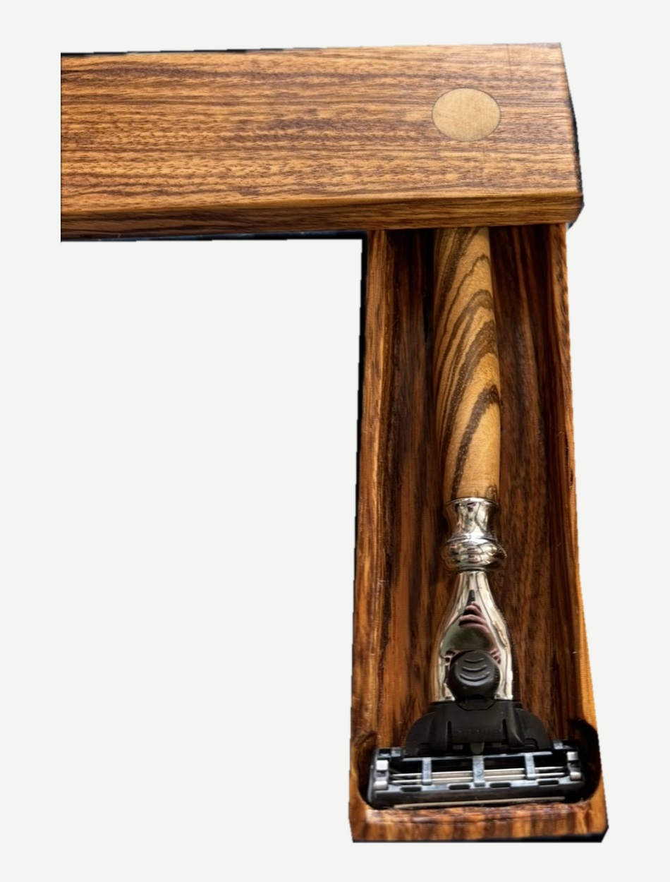 Open wooden box showing the razor inside